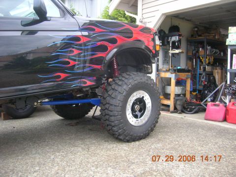 1996 Ford Bronco - This modified SUV features custom flame graphics and an aggressive stance with oversized tires.