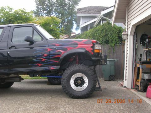 1996 Ford Bronco - Customized 1996 Ford Bronco shows off flame decals and off-road tires.