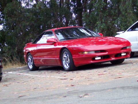 1995 Ford Probe - Red 1995 Ford Probe parked outdoors. A white vehicle is visible to the right.