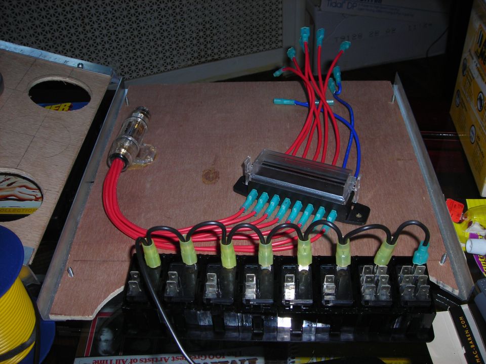 Fuse box with red and blue wires connected to multiple fuse slots. A large inline fuse holder is also visible