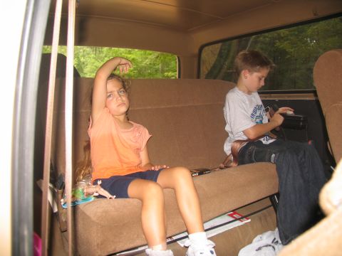 1995 Ford C-350 (Centurion Conversions) - Children ride in the back seat of a vehicle during a trip.