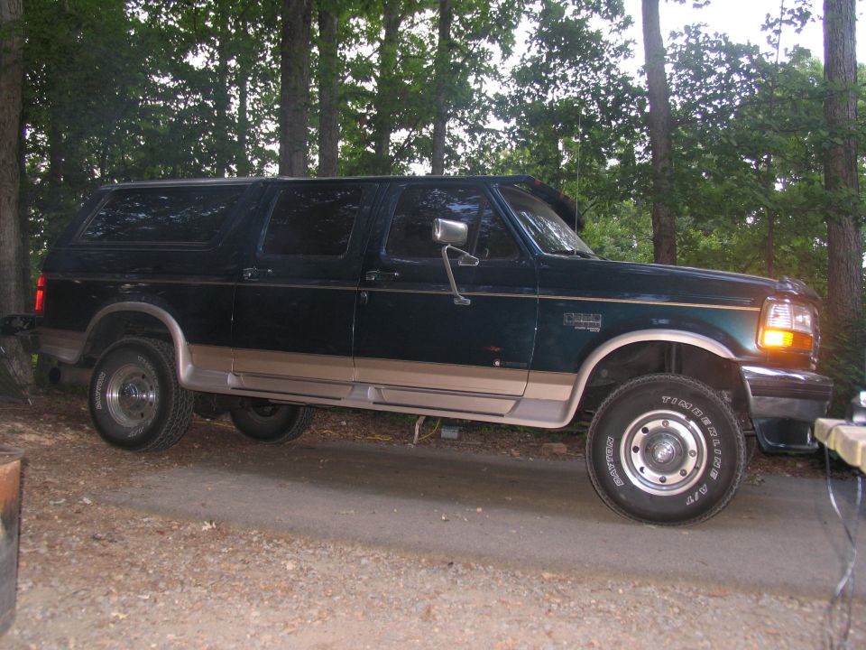 1995 Ford C-350 Centurion Conversions SUV, dark green with tan trim, side view