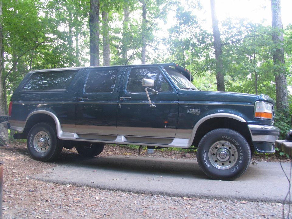 1995 Ford C-350 (Centurion Conversions) SUV, side view, dark green with tan trim