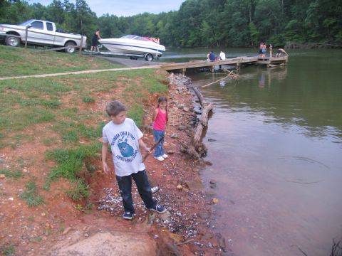 1995 Ford C-350 (Centurion Conversions) - Family at the lake with a boat being launched from a trailer.