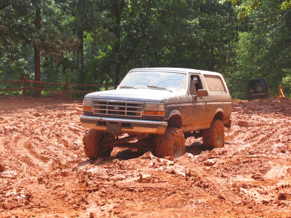 1995 Ford Bronco off-roading in mud