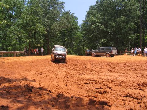 1995 Ford C-350 (Centurion Conversions) - Off-road vehicles navigate a muddy track during an event in July 2006.