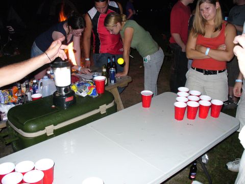 1991 Ford Probe - A group of friends appears to be enjoying a nighttime gathering with a game of beer pong.