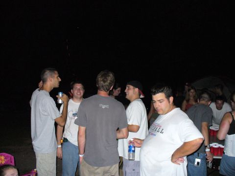1991 Ford Probe - People gathered outdoors at night, with some holding beverages and a beer pong setup visible.