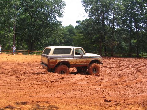 1995 Ford C-350 (Centurion Conversions) - Ford Bronco struggling in thick mud during an off-road event.