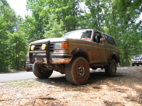 1995 Ford C-350 (Centurion Conversions) - This 1992 Ford Bronco is covered in mud and equipped with off-road tires.