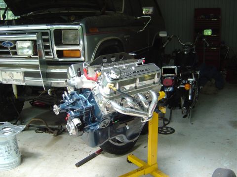 1986 Ford Bronco - Engine swap project a Ford Racing engine and a Ford Bronco in a garage.