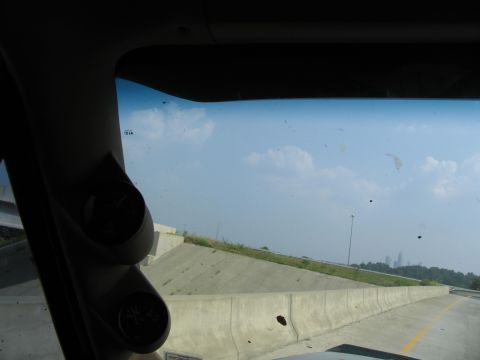 1995 Ford C-350 (Centurion Conversions) - View from inside a vehicle showing aftermarket gauges and a highway scene with a city in the distance.