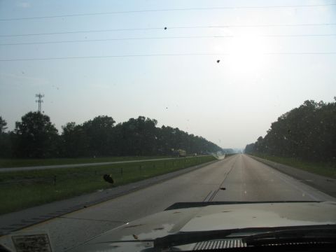 1995 Ford C-350 (Centurion Conversions) - View from inside a vehicle driving down a highway on a hazy day.