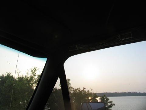 1995 Ford C-350 (Centurion Conversions) - Looking out from the interior of a vehicle towards a lake at sunset.