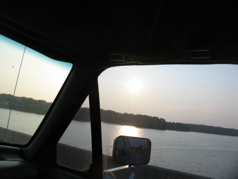 1995 Ford C-350 (Centurion Conversions) - Driving across a bridge over a lake at sunset, seen from inside the vehicle.