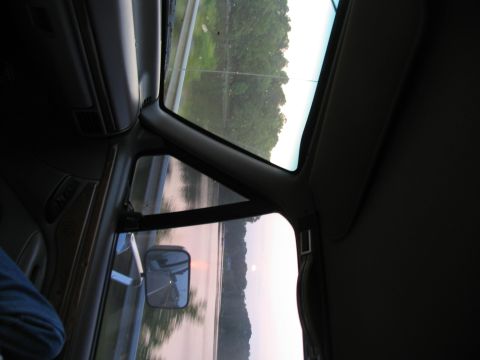 1995 Ford C-350 (Centurion Conversions) - Interior view of a 1995 Ford C-350 (Centurion Conversions) with a reflection of the road in the side mirror.