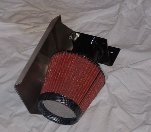 1998 Ford Crown Victoria - red conical air filter mounted on a stainless steel heat-shield bracket, photographed on a white cloth background.