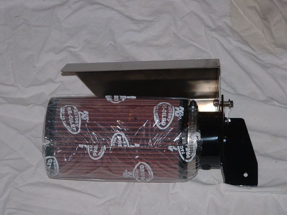 Plastic-wrapped K&N cone air filter on stainless heat shield, side view