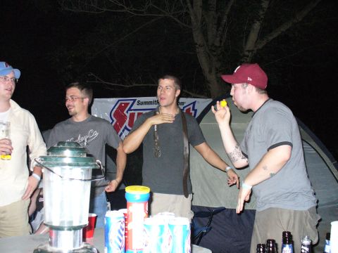 1991 Ford Probe - Friends gather around a table with drinks and a lantern at an outdoor event.