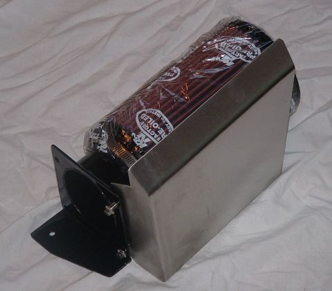 1998 Ford Crown Victoria - wrapped cone air filter on a stainless heat-shield box with a black mounting bracket, shown on white cloth.