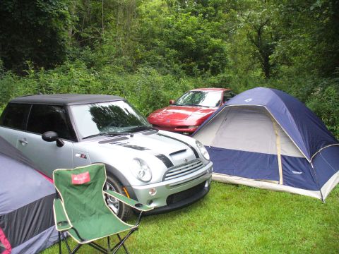 1991 Ford Probe - A silver Mini Cooper S and a red Ford Probe are parked in a grassy area with tents set up.