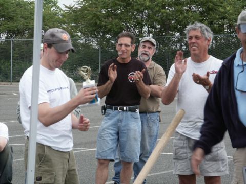2001 Mercury Grand Marquis - Men applaud as one man receives a trophy at an outdoor event.