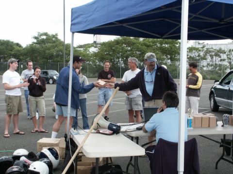 2001 Mercury Grand Marquis - An outdoor event with people gathered under a tent, possibly a competition or award ceremony.