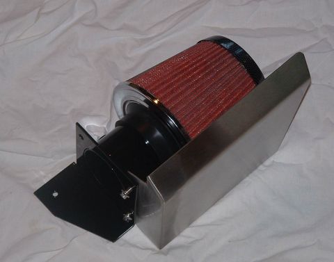 1998 Ford Crown Victoria - red conical air filter mounted on a stainless steel heat-shield bracket with mounting hardware, on white cloth.