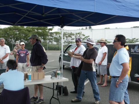 2001 Mercury Grand Marquis - Outdoor event with men, a table of awards, and a vehicle visible in the background.