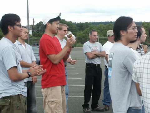 2001 Mercury Grand Marquis - Several men stand together in an outdoor setting, with trees in the background.