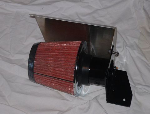 1998 Ford Crown Victoria - red conical air filter on a stainless steel heat-shield bracket with a black mounting bracket, photographed on white cloth.