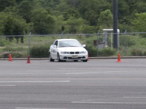 2001 Mercury Grand Marquis - A white sedan navigates a course marked by orange cones during an event.