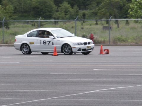 2001 Mercury Grand Marquis - A white coupe with racing numbers '197E' is seen on a race track, navigating around orange cones.