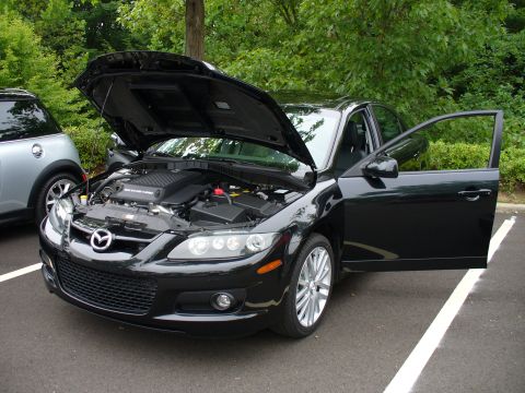 1991 Ford Probe - Black Mazda 6 with hood and driver door open, parked next to a silver Mini Cooper.