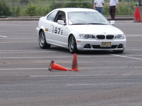 2001 Mercury Grand Marquis - A white BMW 3 Series coupe navigates a course marked by orange traffic cones.