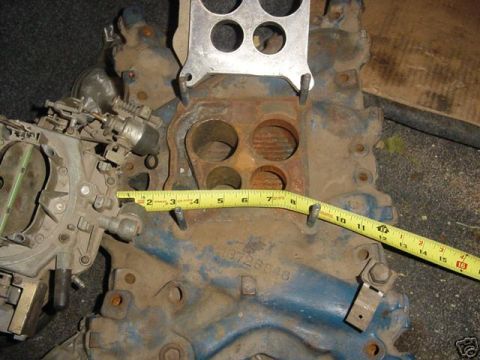 1978 Ford F-250 - Close-up of an engine intake manifold and carburetor, with a tape measure for scale. Part number 13728546 is visible.