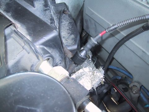 1994 Ford Bronco - Close-up view of engine bay components, including wiring, hoses, and insulation.