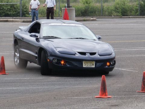 2001 Mercury Grand Marquis - A dark blue 2001 Pontiac Firebird navigates a course marked by orange cones.