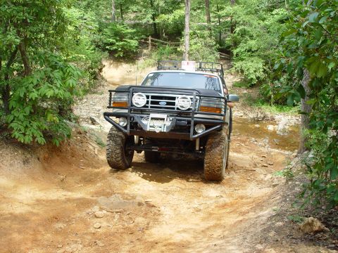 1996 Ford Bronco - This 1996 Ford Bronco navigates a challenging off-road course through a wooded area.