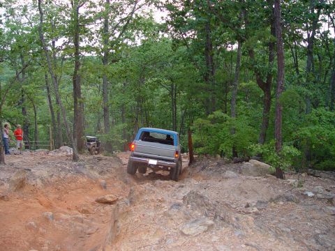 1996 Ford Bronco - Ford Bronco tackles a challenging rocky trail in a wooded area.