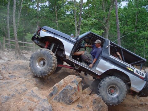 1996 Ford Bronco - Modified Ford Bronco navigates a challenging rocky terrain during an off-road excursion.