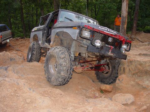 1996 Ford Bronco - Modified Ford Bronco navigating a rocky trail with a second vehicle visible in the background.