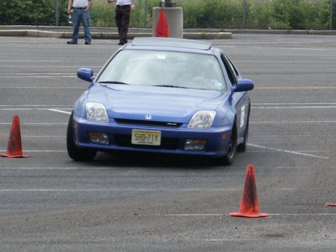 2001 Mercury Grand Marquis - A blue Honda Prelude navigates a course marked by orange traffic cones on a paved surface.
