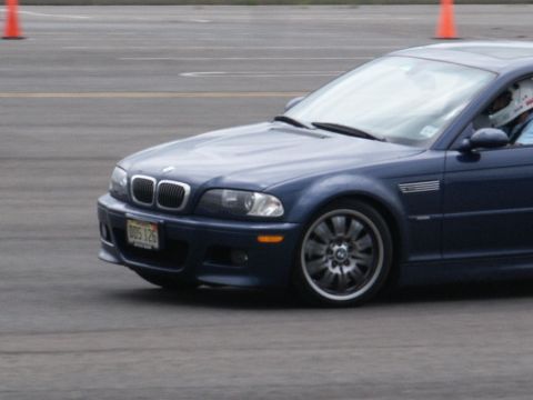 2001 Mercury Grand Marquis - A blue BMW M3 is seen on a track, displaying its front quarter view. The license plate is visible and reads DDS 126.