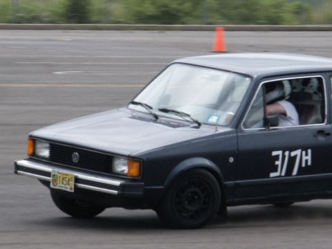 2001 Mercury Grand Marquis - Volkswagen Rabbit GTI on a race track, showing its distinctive body style and racing numbers.