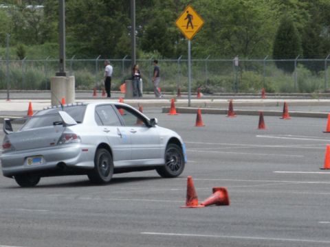 2001 Mercury Grand Marquis - A silver sedan with a large rear spoiler navigates a course marked by orange traffic cones.