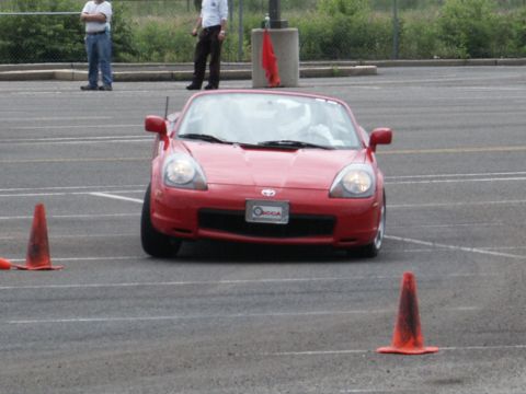 2001 Mercury Grand Marquis - Red Toyota MR2 Spyder navigating a course marked by traffic cones.