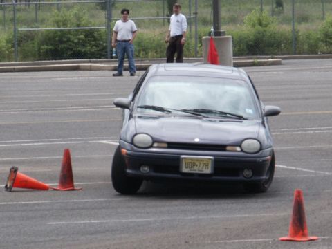 2001 Mercury Grand Marquis - A dark sedan maneuvers through a cone course in a parking lot.