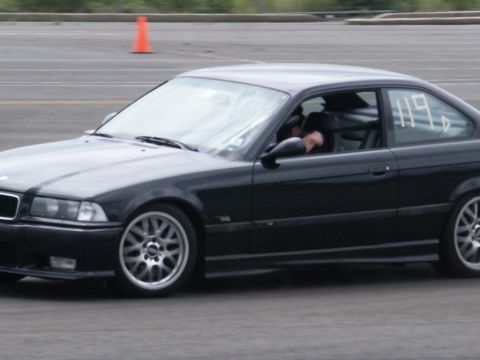 2001 Mercury Grand Marquis - A black coupe, possibly a BMW E36, is on a track with a racing number visible.