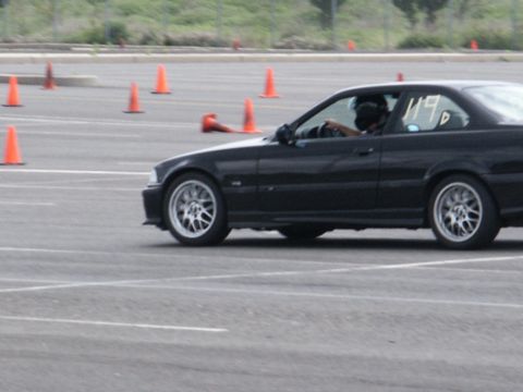 2001 Mercury Grand Marquis - A black coupe with racing number 119 navigates a course marked by orange cones.